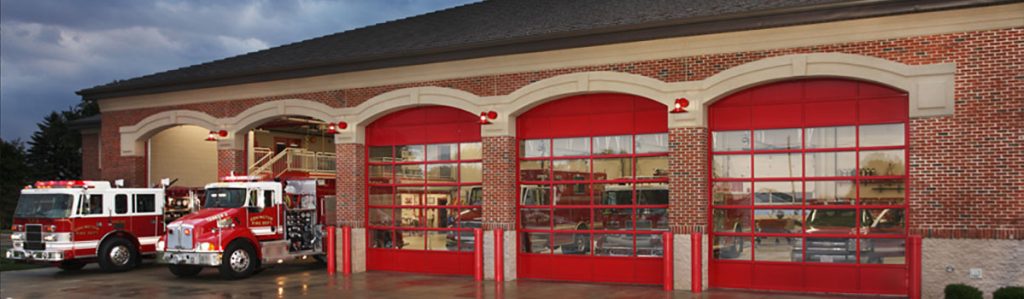 A fire station with red garage doors